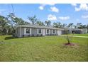 Lovely single-story home with freshly manicured landscaping on a bright, sunny day at 77 Redwood Rd, Ocala, FL 34472