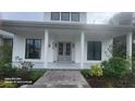 Inviting front porch with elegant double doors and manicured landscaping at 2719 Brookline Ave, New Smyrna Beach, FL 32168