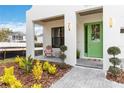 Inviting front porch with green door and seating area at 1018 Stetson St, Orlando, FL 32804