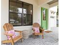 Relaxing front porch with wooden chairs and side table at 1018 Stetson St, Orlando, FL 32804