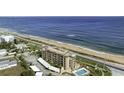 An oceanfront condo building features a community pool, covered parking, and direct beach access at 2390 Ocean Shore Blvd # 1040, Ormond Beach, FL 32176