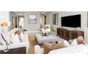 Living room features neutral colors, comfy couches, and a large TV at 2105 Aibonito Cir, Clermont, FL 34711
