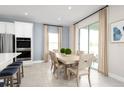 Light-filled dining area with a wooden table, seating for six, and sliding glass doors to the outdoors at 5043 Bear Lake Loop, Deland, FL 32724