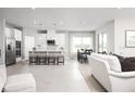 Bright open floorplan featuring a kitchen with stainless steel appliances, quartz countertops, and tile flooring at 500 Crossings Ave, St Cloud, FL 34771