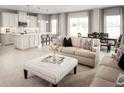Open concept kitchen with island, white cabinets, and stainless steel appliances at 5781 Anders Way, Saint Cloud, FL 34771