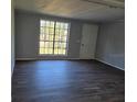 Bright and airy living room featuring new laminate flooring and a large window at 5840 Nw 16Th St, Ocala, FL 34482