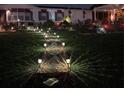 Lit walkway leading to the home at night at 621 Sw 79Th Ct, Ocala, FL 34474