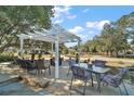 Relaxing patio area with pergola and seating at 621 Sw 79Th Ct, Ocala, FL 34474