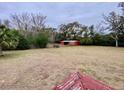 Open farmland with a red barn and wooden fence at 13660 Se 80Th Ave, Summerfield, FL 34491