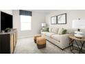 Cozy bonus room with a sofa, ottomans, and a media console at 314 Biltmore Blvd, Dundee, FL 33838