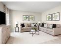 Bright living room featuring two sofas, a coffee table, and artwork at 314 Biltmore Blvd, Dundee, FL 33838
