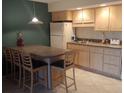 Kitchen features light wood cabinets and a breakfast bar at 3700 S Atlantic Ave # 405, New Smyrna Beach, FL 32169