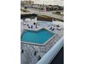 Community pool with surrounding patio furniture at 3700 S Atlantic Ave # 405, New Smyrna Beach, FL 32169