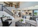 Two-story living room with open floor plan and kitchen views at 3785 Voyageurs Ct, Apopka, FL 32712
