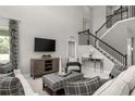 Open living space featuring high ceilings and a modern aesthetic at 3785 Voyageurs Ct, Apopka, FL 32712