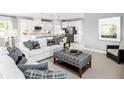 Open living room with white sofa and view into kitchen at 7427 Sw 108Th St, Ocala, FL 34476