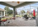 Relaxing screened patio with seating area, fire pit, and backyard views at 8320 Sw 82Nd Loop, Ocala, FL 34481