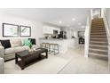 Open floorplan with living room, kitchen, and staircase at 2302 Incandescent Way, South Daytona, FL 32119