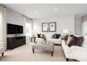 Bright living room boasts recessed lighting, neutral tones, and comfortable seating arrangements at 424 Hammock Oaks Blvd, Lady Lake, FL 32159