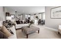 Open-concept living room flows into the kitchen and dining area, perfect for entertaining at 424 Hammock Oaks Blvd, Lady Lake, FL 32159