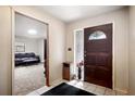 Inviting entryway featuring a decorative wood door and tile flooring, leading to a comfortable living space at 5030 Alderman Rd, Lakeland, FL 33810