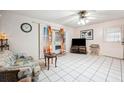 Cozy living room with tile flooring, comfortable seating, and a sliding glass door for easy outdoor access at 5030 Alderman Rd, Lakeland, FL 33810