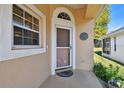 Front door entrance with a screen door and a clock at 152 Travis Ln, Davenport, FL 33837