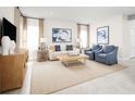 Living Room with a beige sofa and blue armchairs at 5004 Balsam Falls Rd, Deland, FL 32724