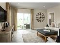 Gathering room with sliding glass doors leading to a patio and a large clock at 5016 Balsam Falls Rd, Deland, FL 32724