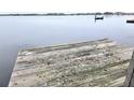 Close-up view from the end of a rustic wooden dock on a serene lake at 3621 Conine E Dr, Winter Haven, FL 33881