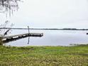 Scenic view of the lake with a wooden dock extending into the water at 3621 Conine E Dr, Winter Haven, FL 33881