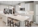 Modern kitchen with white cabinets, large island, and stainless steel appliances at 7405 Sw 108Th St, Ocala, FL 34476