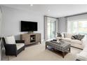 Bright Gathering room with a comfortable couch and plenty of natural light at 437 Hammock Oaks Blvd, Lady Lake, FL 32159