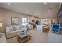 Inviting open-plan living space with modern kitchen, cozy seating, and ample natural light at 633 Highfalls Ave, Debary, FL 32713