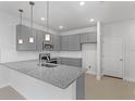 Modern kitchen featuring granite countertops, stainless steel appliances, and pendant lighting at 6919 Five Oaks Dr, St Cloud, FL 34773