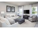 Bright living room featuring stylish furniture, elegant decor, and large windows with scenic views at 1628 Covey Rise Ter, Winter Haven, FL 33884