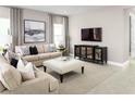 Comfortable living room with a modern entertainment center and neutral decor at 1636 Covey Rise Ter, Winter Haven, FL 33884
