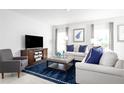 Cozy living room with comfortable seating, a modern entertainment center and elegant decor at 2152 Tennessee St, Sumterville, FL 33585