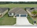 Aerial view of a beautiful single-Gathering home with a lush green lawn and a spacious two-car garage at 9773 Sw 63Rd Loop, Ocala, FL 34481