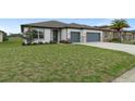 Inviting single-Gathering home featuring a well-manicured lawn, landscaping and two-car garage at 9773 Sw 63Rd Loop, Ocala, FL 34481