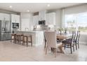 Modern kitchen with stainless appliances, a breakfast bar, and adjacent dining area at 1262 Whispering Ln, Minneola, FL 34715