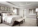 Serene bedroom with tray ceiling, neutral decor, and a comfortable king-size bed at 7325 Sw 108Th St, Ocala, FL 34476