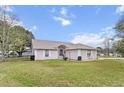 Attractive single-Gathering home showcasing a lush green lawn and welcoming facade at 12 Almond Ter, Ocala, FL 34472