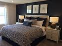 Comfortable bedroom with a king-size bed, stylish decor, and plenty of natural light from the window at 3828 Denali Dr, Apopka, FL 32712