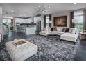 Spacious and modern open-concept living room with a large kitchen island and hardwood floors at 3828 Denali Dr, Apopka, FL 32712