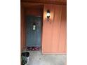 Entrance to unit with a storm door, outdoor light fixture, and a welcome mat at 722 E Michigan St # 145, Orlando, FL 32806