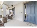 Inviting front porch featuring stone columns and comfortable seating at 8750 Sw 79Th Loop, Ocala, FL 34481