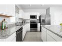 Modern kitchen featuring granite countertops, stainless steel appliances, and bright white cabinetry at 4226 Cattail Marsh Dr, Lakeland, FL 33811