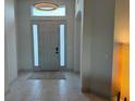 Bright foyer features neutral tile flooring and a stylish light fixture at 1567 Lake Reserve Dr, Deland, FL 32724
