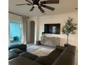 A stylish living room with modern decor, a large television, and comfortable seating at 1567 Lake Reserve Dr, Deland, FL 32724